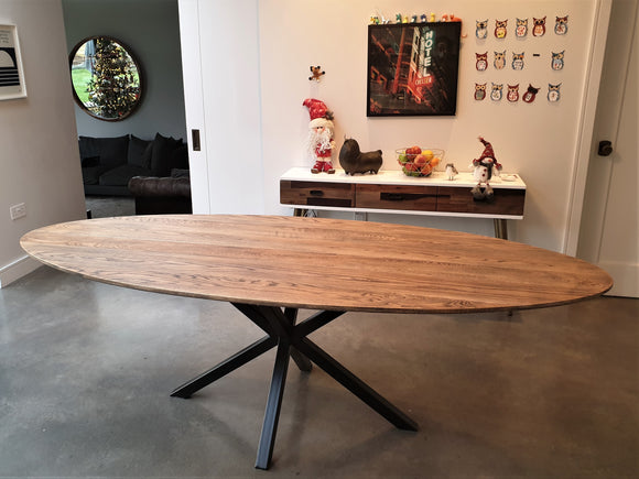 Handcrafted oval dining table with star/spider base